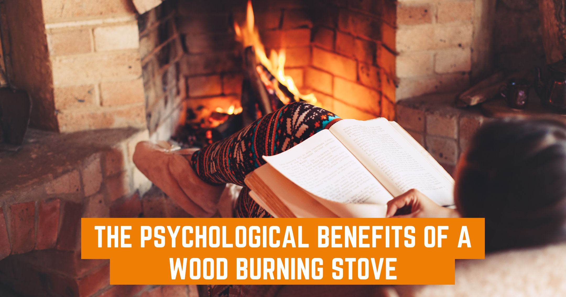 someone reading a book in front of a log burner